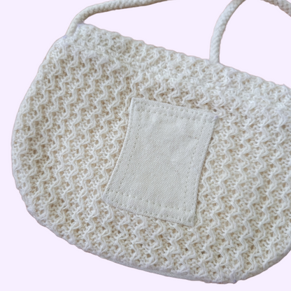 cream woven bag with button clasp