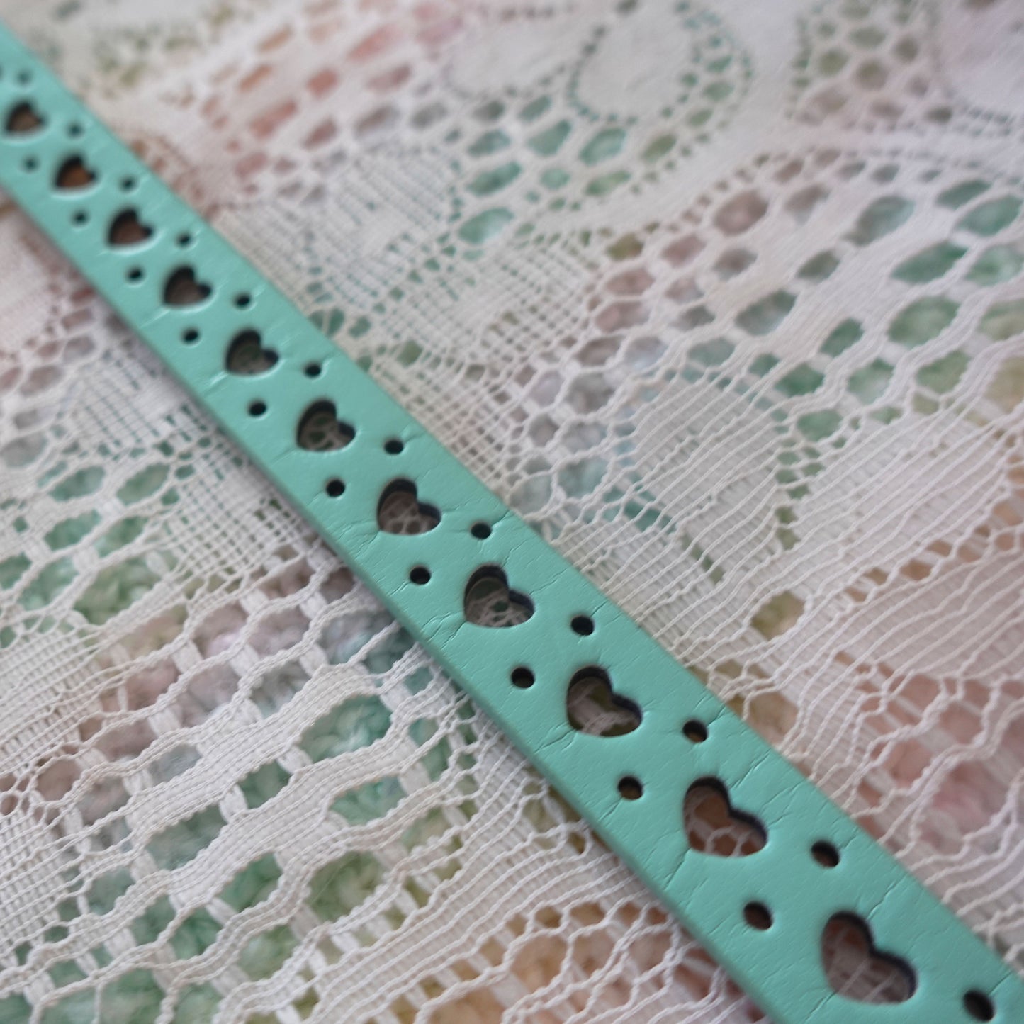 teal belt with heart cutouts